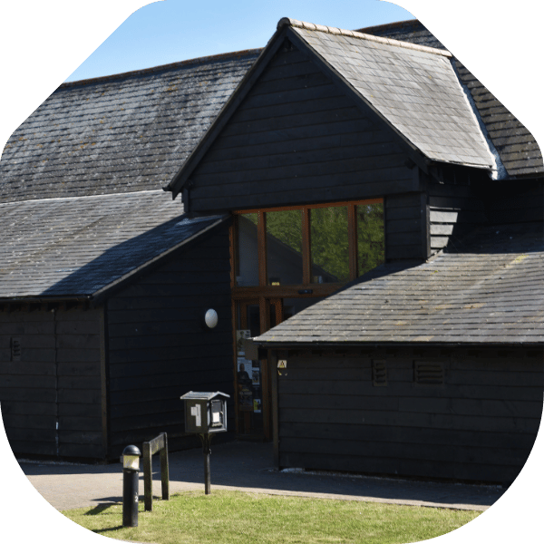 Image of Hanger Farm; a black barn with large entrance.